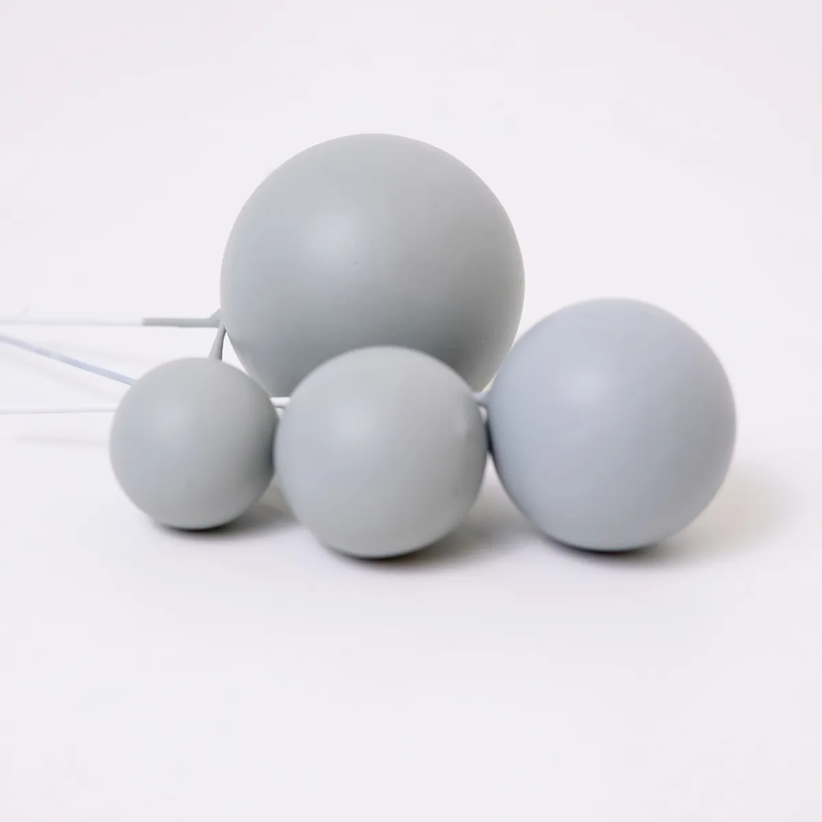 Vier matt hellgraue, runde Bubbles Kucheneinstecker in unterschiedlichen Größen