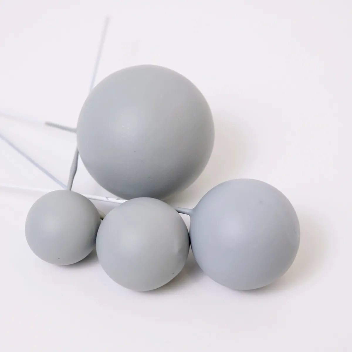Vier matt hellgraue, runde Bubbles Kucheneinstecker in unterschiedlichen Größen