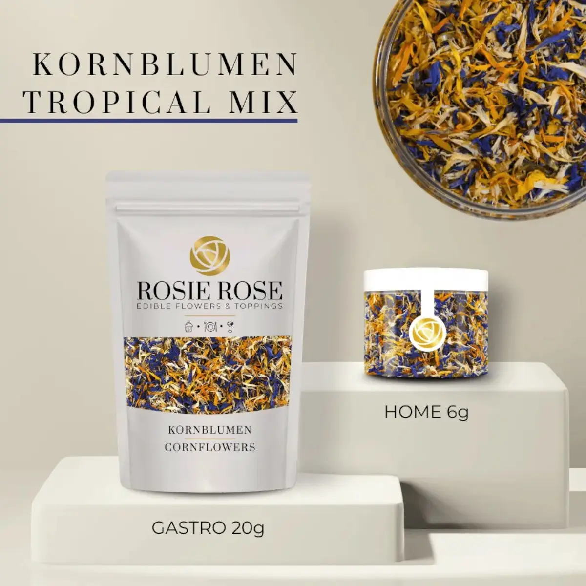 Rosie Rose Kornblumenblüten Tropical Mix im weißen 20-g-Beutel und in einer transparenten 6-g-Dose, daneben eine Nahaufnahme der Blütenmischung.